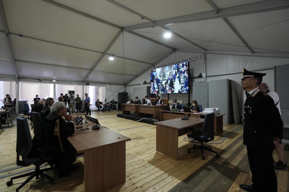 Lawyers and Judges attend the opening of the first hearing of the trial for the Morandi bridge collapse at Genoa's Palace of Justice Thursday, July 7, 2022. Forty-three people were killed when a large stretch of the Morandi Bridge broke off, August 14, 2018, on the eve of one of Italy's biggest vacation holidays. (AP Photo/Antonio Calanni)