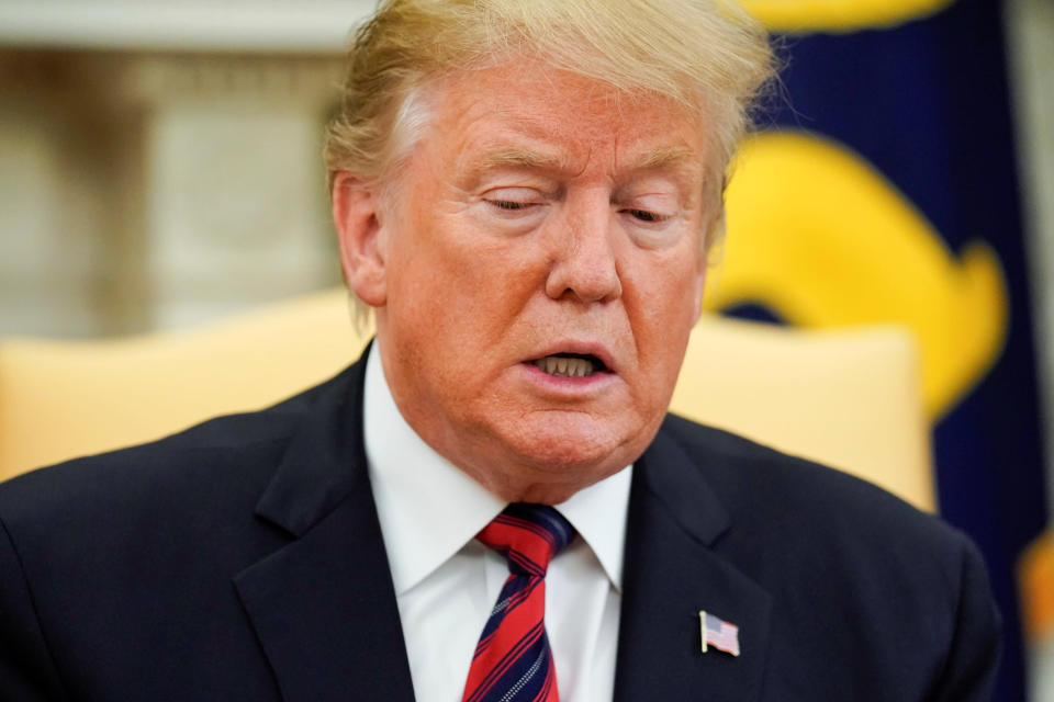 President Trump pauses during a meeting at the White House on Friday. (Jonathan Ernst/Reuters)