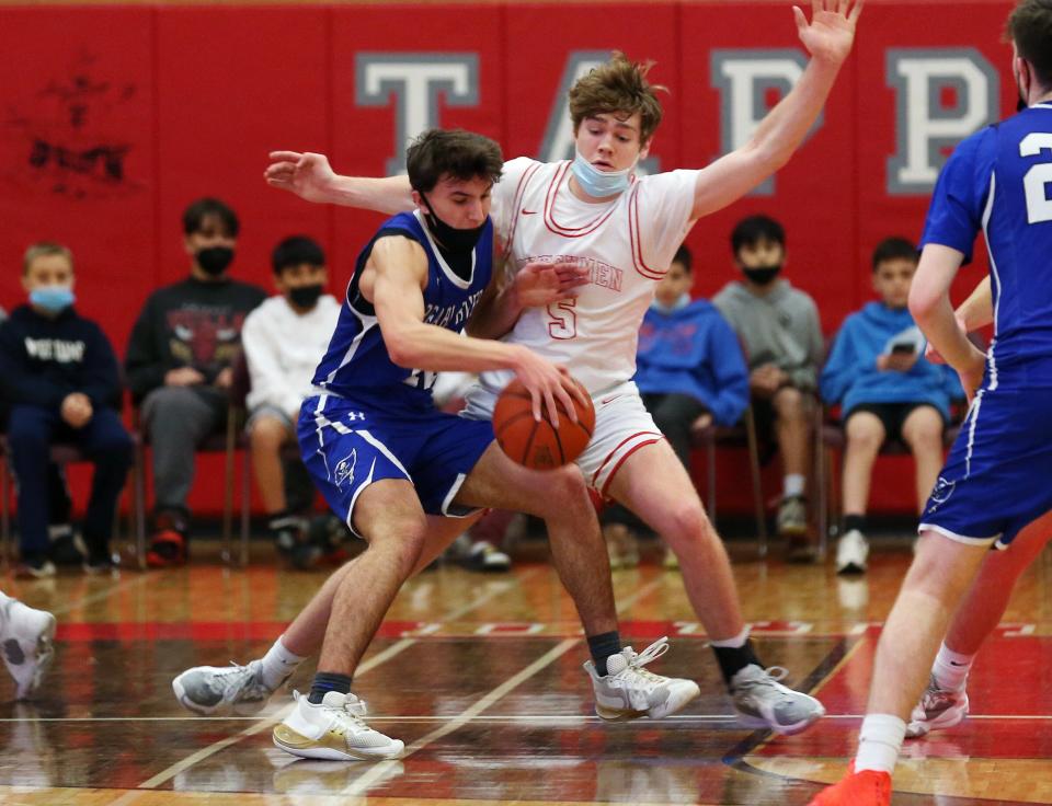 Pearl River's Thomas Bertussi (12) tries to drive around  Tappan Zee's Colin Cunney (5) during boys basketball action at Tappan Zee High School Jan. 20, 2022. 