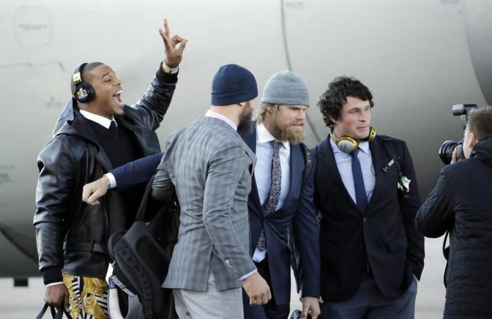 Carolina Panthers’ Cam Newton jumps into a picture being taken of A.J. Klein, right to left, Greg Olsen and Derek Anderson after getting off the plane at the Mineta San Jose International Airport as they arrive for the NFL Super Bowl football game Sunday, Jan. 31, 2016, in San Jose, Calif. The Panthers play the Denver Broncos on Sunday, Feb. 7, 2015, in Super Bowl 50. (AP Photo/David J. Phillip)