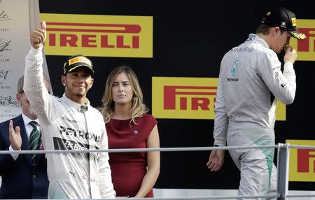 Winner Mercedes Formula One driver Lewis Hamilton (L) of Britain celebrates on the podium besides second-placed team mate Nico Rosberg (R) of Germany at the end of the Italian F1 Grand Prix in Monza September 7, 2014. REUTERS/Max Rossi