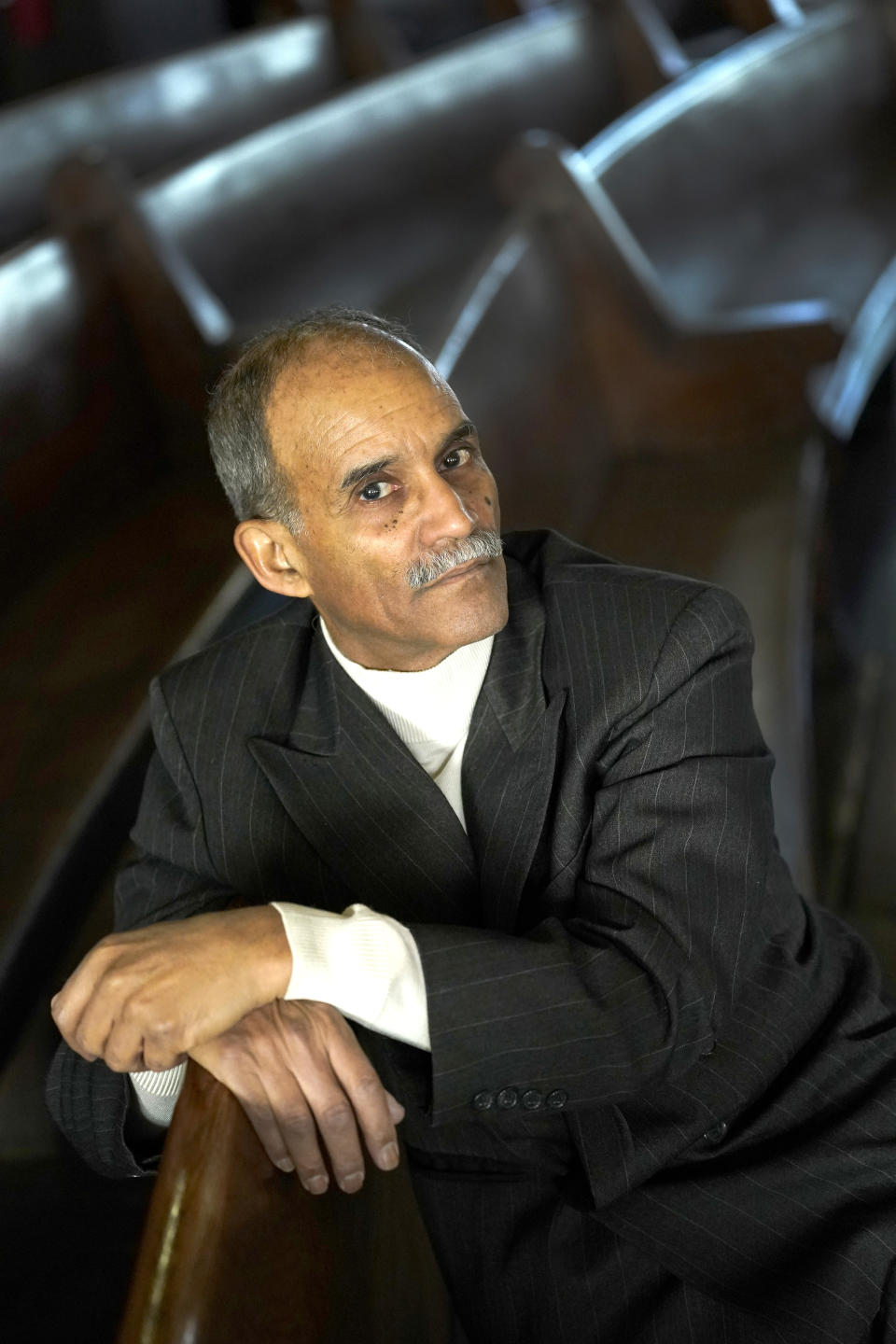 Tony Burroughs, CEO of Chicago's Center for Black Genealogy, sits in a pew Tuesday, Feb. 9, 2021, at the historic Quinn Chapel, the first Black church of any denomination in Chicago. Burroughs began tracing his family's ancestry in 1975, leading him to Oakridge Cemetery, where he found his grandparents, his great uncles and aunts and his great-great grandparents.While no official database exists, historically Black cemeteries are scattered throughout the country, telling the story of the United States' deep history of cemetery segregation. (AP Photo/Charles Rex Arbogast)