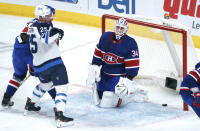 Montreal Canadiens goaltender Jake Allen reacts to a goal by Winnipeg Jets' Paul Stastny, left, during first-period NHL hockey game action in Montreal, Thursday, March 4, 2021. (Paul Chiasson/The Canadian Press via AP)