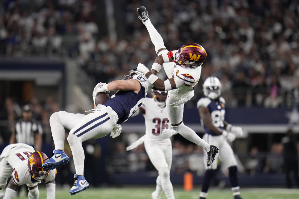 Dallas Cowboys tight end Jake Ferguson (87) cannot catch a pass while being defended by Washington Commanders safety Percy Butler, top, during the second half of an NFL football game Thursday, Nov. 23, 2023, in Arlington, Texas. (AP Photo/Julio Cortez)
