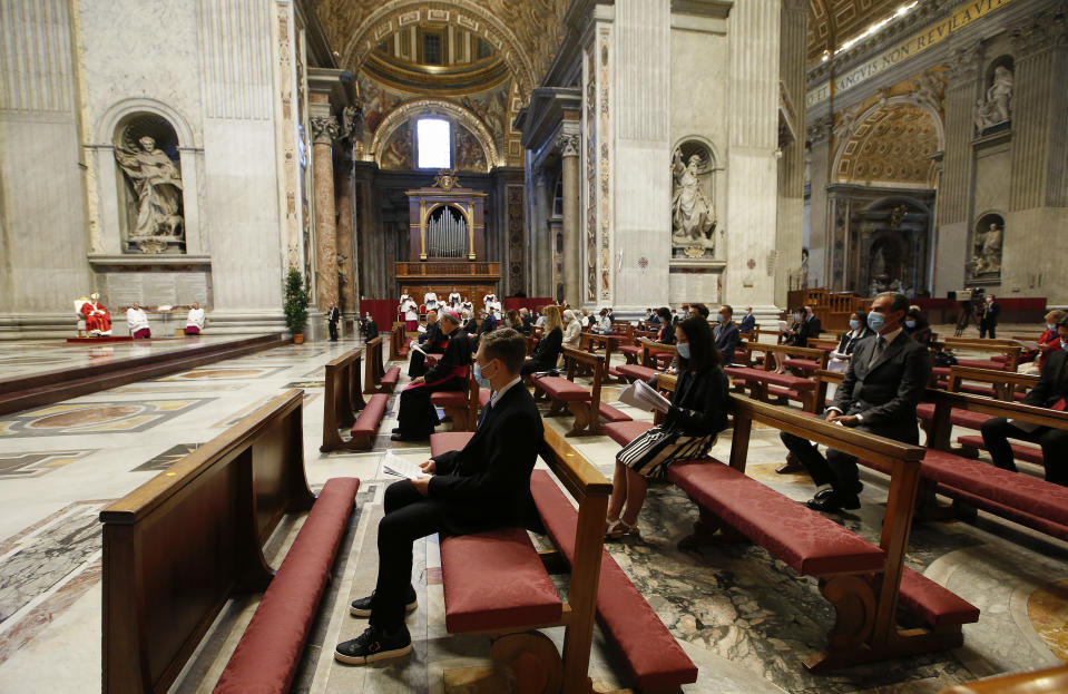 Pope Francis, top left, celebrates Mass in St. Peter's Basilica at the Vatican, Sunday, May 31, 2020. Francis celebrates a Pentecost Mass in St. Peter's Basilica on Sunday, albeit without members of the public in attendance. He will then go to his studio window to recite his blessing at noon to the crowds below. The Vatican says police will ensure the faithful gathered in the piazza keep an appropriate distance apart. (Remo Casilli/ Pool Photo via AP)