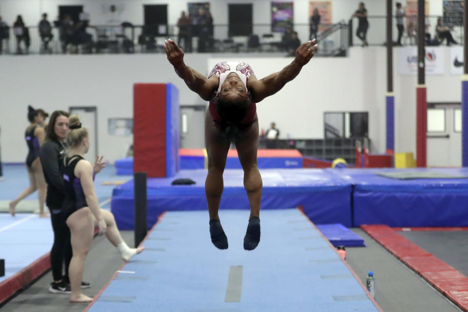 Simone Biles executes a flip for her floor exercise routine during training at the Stars Gymnastics Sports Center in Katy, Texas, Monday, Feb. 5, 2024. Biles begins preparations for the Paris Olympics when she returns to competition at the U.S. Classic in Hartford, Connecticut on Saturday. Biles, who cited mental health concerns while removing herself from several competitions at the Tokyo Olympics, says she is better prepared for the pressure competing presents this time around. (AP Photo/Michael Wyke)