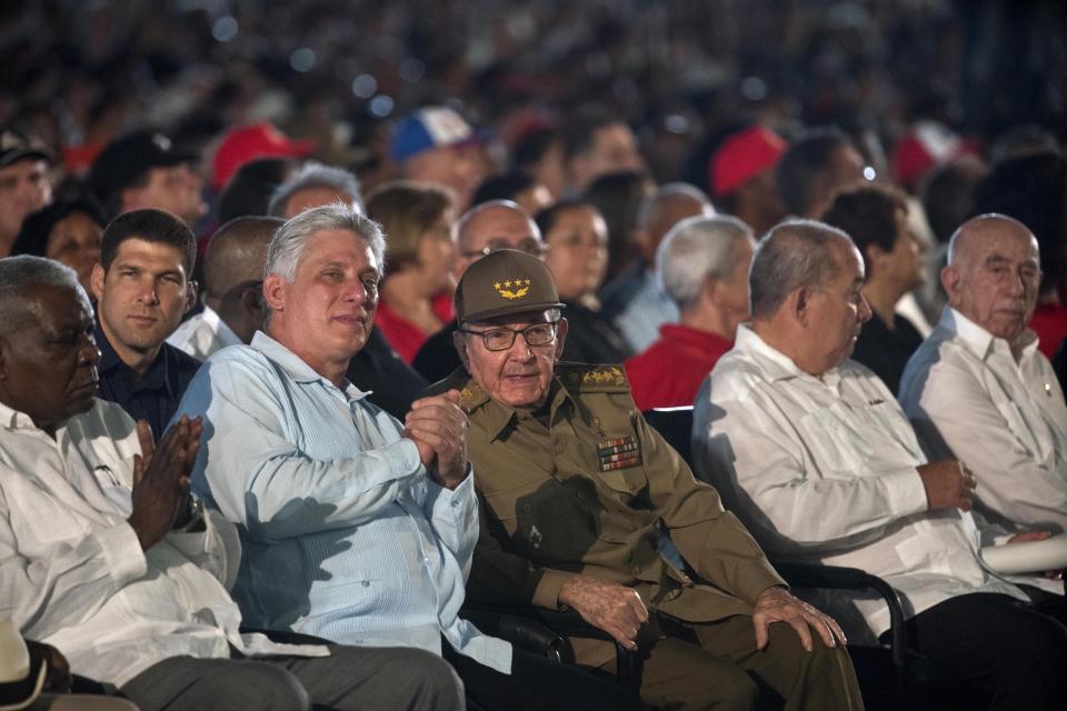 FILE - In this July 26, 2018 file photo, Cuba's former President Raul Castro, center, and President Miguel Diaz-Canel, second left, attend an event celebrating Revolution Day in Santiago, Cuba. On Monday, April 19, 2021, Cuba's Communist Party congress chose Díaz-Canel to be its leader, adding that post to the title of president he assumed in 2018, replacing his mentor Raul Castro and sealing a political dynasty that had held power since the 1959 revolution. (AP Photo/Ramon Espinosa, File)