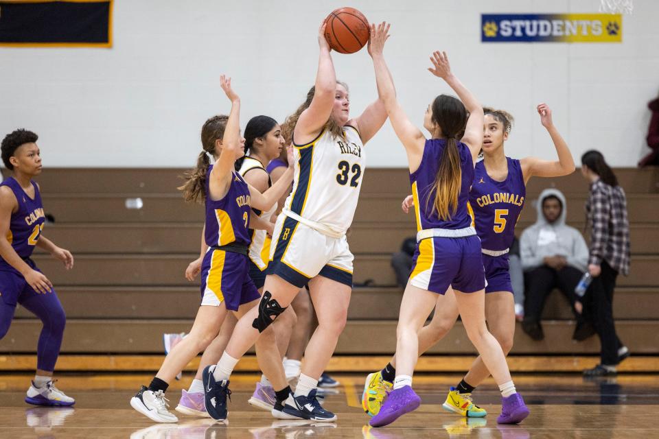 South Bend Riley's Kaelynn Howell (32) passes the ball as South Bend Clay's Rachel Hunt (2 defends during the South Bend Clay-South Bend Riley high school basketball game on Friday, January 20, 2023, at Riley High School in South Bend, Indiana.