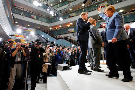 Christian Democratic Union (CDU) party leader and German Chancellor Angela Merkel leaves the stage after her speech after the announcement of poll results in the German general election (Bundestagswahl) in CDU headquarters in Berlin, Germany, September 24, 2017. REUTERS/Fabrizio Bensch