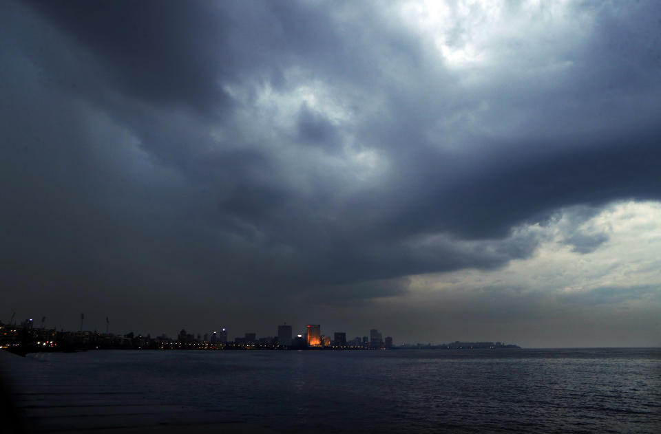 Dark clouds hang over the city ahead of cyclone Nisarga making landfall in Mumbai, India, Tuesday, June 2, 2020. The cyclone made landfall Wednesday south of India's financial capital of Mumbai, with storm surge threatening to flood beaches and low-lying slums as city authorities struggle to contain the coronavirus pandemic. (AP Photo/Rajanish Kakade)