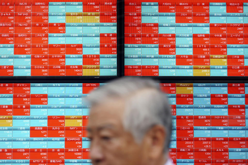 A man walks past an electronic stock board showing Japan's Nikkei 225 index at a securities firm in Tokyo Friday, Sept. 13, 2019. Stocks were broadly higher in Asia on Friday after gains overnight on Wall Street. Investors have stepped up buying on hopes for an easing of tensions in the costly trade war between the U.S. (AP Photo/Eugene Hoshiko)