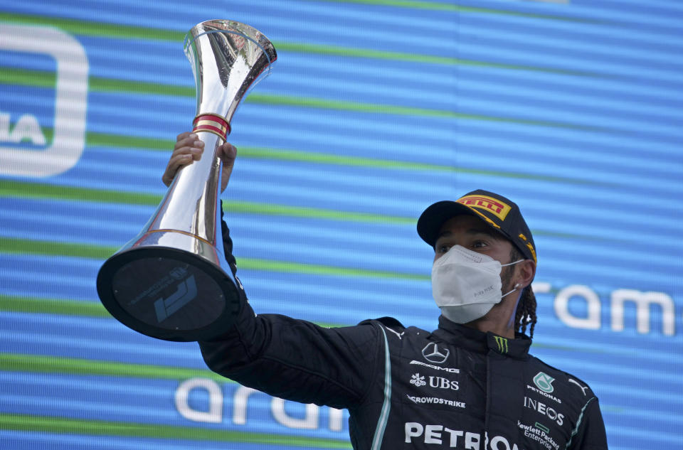 Mercedes driver Lewis Hamilton of Britain lifts his trophy on the podium after winning the Spanish Formula One Grand Prix at the Barcelona Catalunya racetrack in Montmelo, just outside Barcelona, Spain, Sunday, May 9, 2021. (AP Photo/Emilio Morenatti, Pool)
