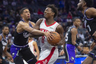 Sacramento Kings' Tyrese Haliburton guards Houston Rockets forward Jae'Sean Tate (8) during the first quarter of an NBA basketball game in Sacramento, Calif., Friday, Jan. 14, 2022. (AP Photo/Randall Benton)