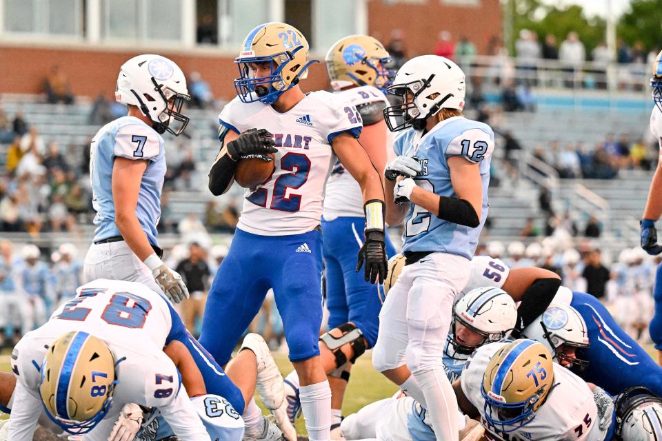 Elkhart’s Gavin Houser (22) scores a touchdown in the second quarter Friday, Sept. 23, 2022, at Leighton Stadium.