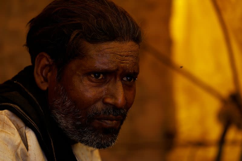 Banwari Singh, 40, a construction worker, sweats as he takes a break at a construction site during a hot summer day in New Delhi