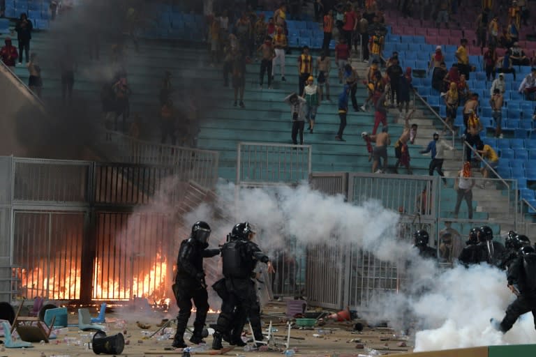 Esperance supporters and riot police clash during a CAF Champions League quarter-final against JS Kabylie near Tunis on April 29.