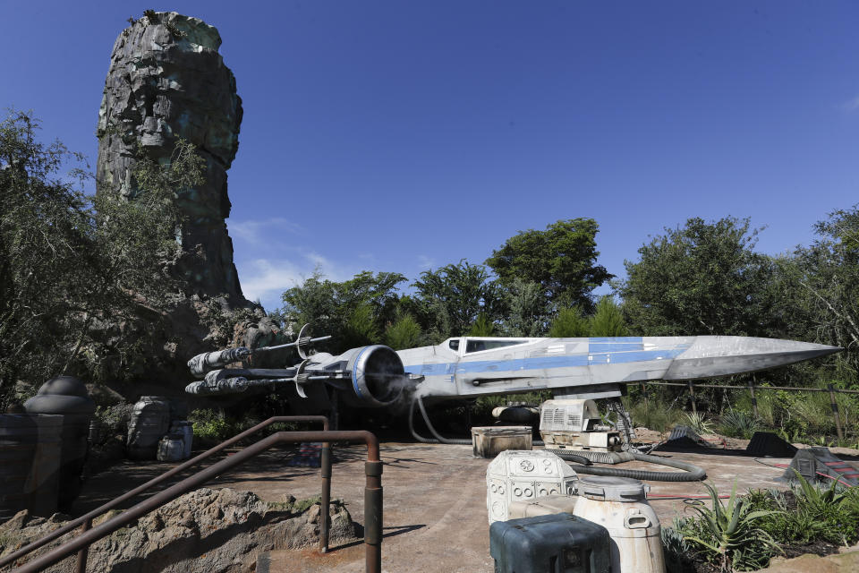 The X-Wing ship stands ready for flight at a display during a preview of the Star Wars themed land, Galaxy's Edge in Hollywood Studios at Disney World, Tuesday, Aug. 27, 2019, in Lake Buena Vista, Fla. The attraction will open Thursday to park guests. (AP Photo/John Raoux)