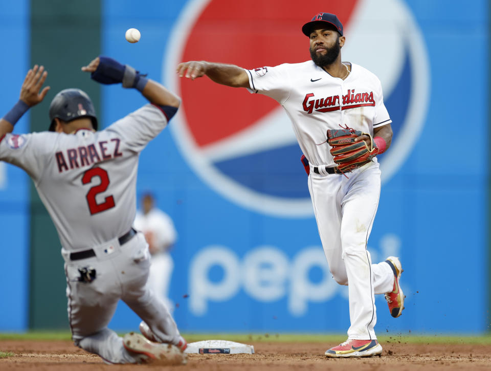 Cleveland Guardians shortstop Amed Rosario throws to first after forcing out Minnesota Twins' Luis Arraez (2) during the fifth inning in the second baseball game of a doubleheader, Tuesday, June 28, 2022, in Cleveland. Jorge Polanco was safe at first. (AP Photo/Ron Schwane)