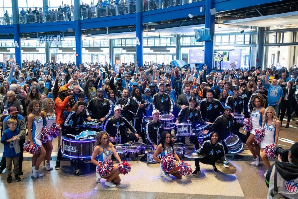 Detroit Lions cheerleaders perform with the drumline members inside  Gate A at Ford Field before the game against Chicago Bears on Sunday.