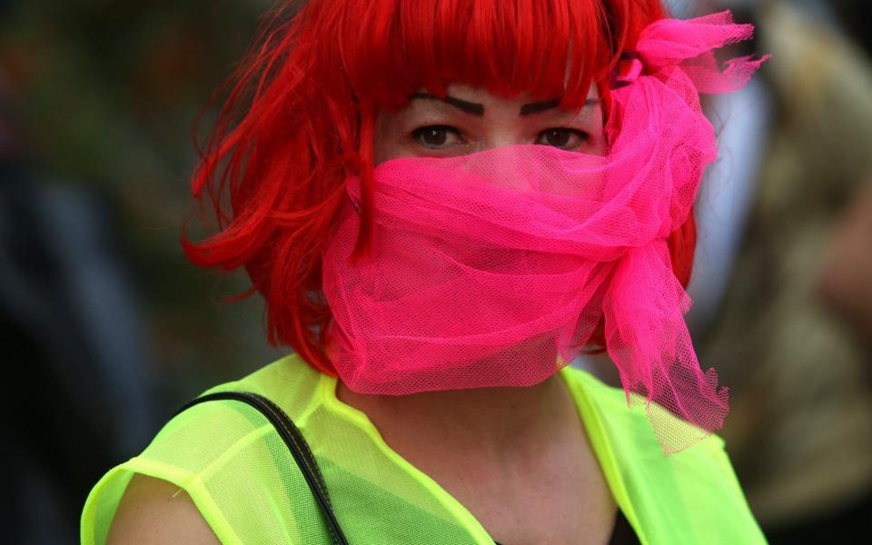 A woman wears a mask to slow the spread of coronavirus in Germany - Adam Berry