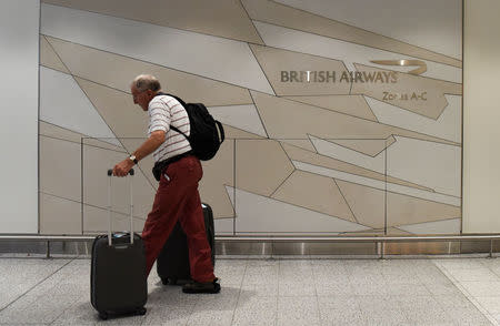 A man arrives at the British Airways check-in desk at Gatwick Airport in southern England, Britain, May 28, 2017. REUTERS/Hannah McKay