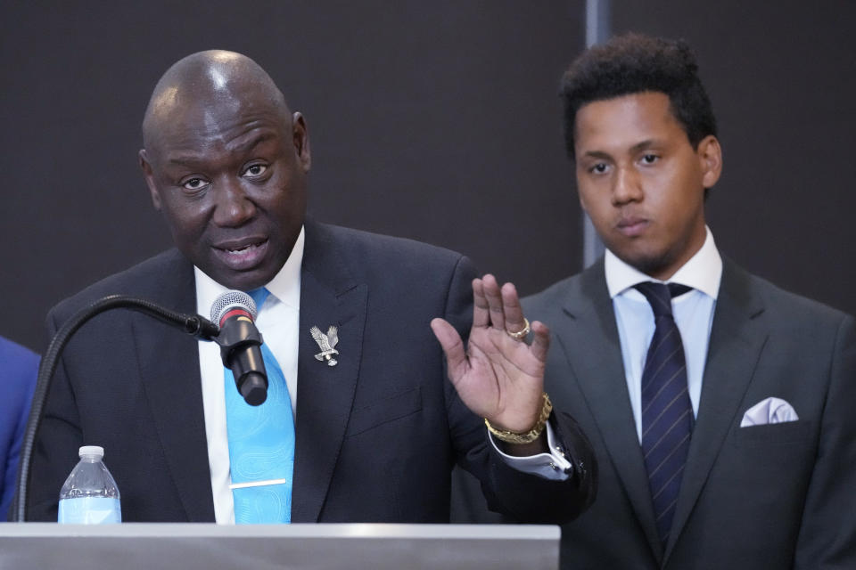 Attorney Ben Crump, left, speaks as former Northwestern quarterback Lloyd Yates, right, listens at a news conference in Chicago, Monday, July 24, 2023. A Northwestern hazing scandal includes multiple sports, men and women, attorneys have said. (AP Photo/Nam Y. Huh)