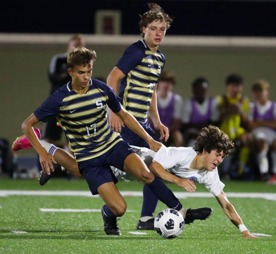 Salesianum's Sean Duffy (left) tangles with Charter School of Wilmington's Michael Capretto in the second half of Salesianum's 2-0 win at Abessinio Stadium, Tuesday, Sept. 19, 2023.