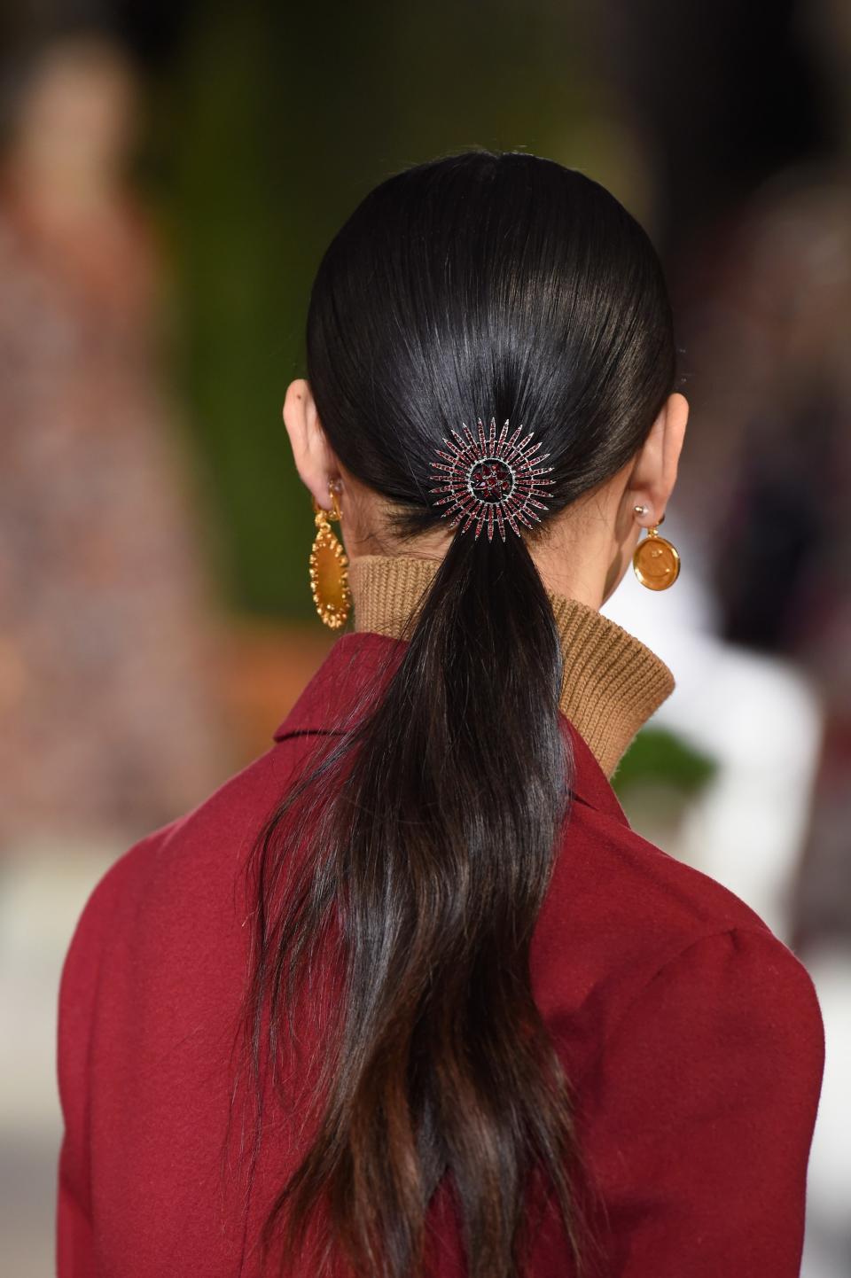 Oscar de la Renta's jet-setting magpie wears her passport stamps on her sleeve—and far-flung treasures in her hair.