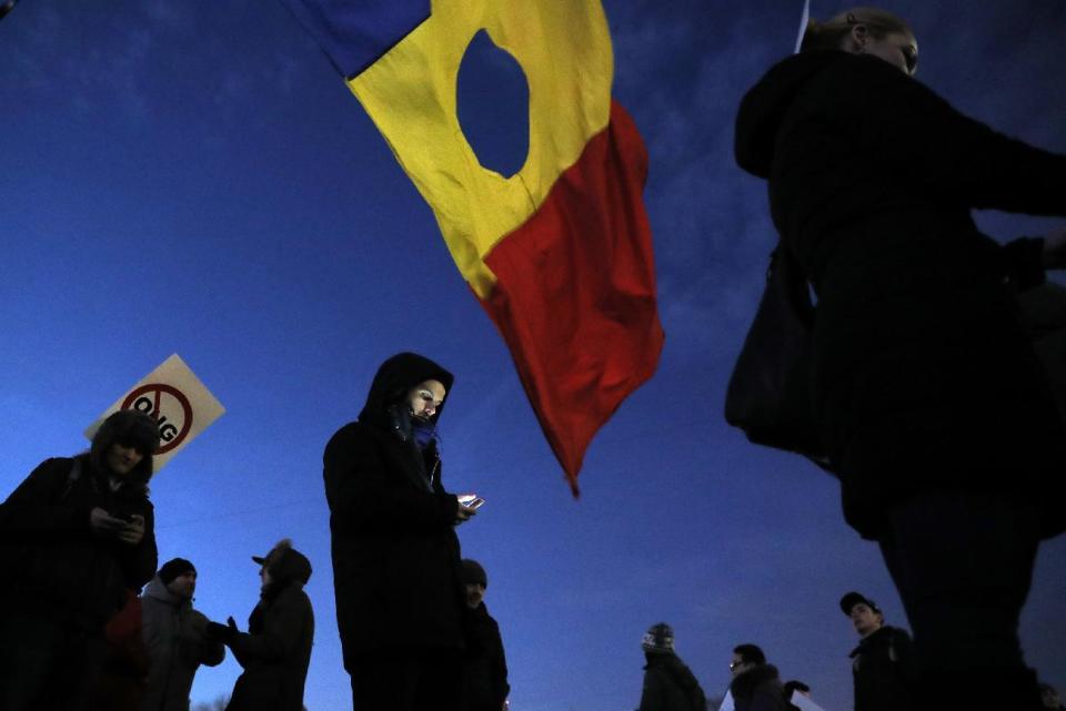 Demonstrators gather during a protest in Bucharest, Romania, Friday, Feb. 3, 2017. Romania's political crisis is deepening over a government decree that may benefit rich and powerful people convicted of corruption. (AP Photo/Vadim Ghirda)