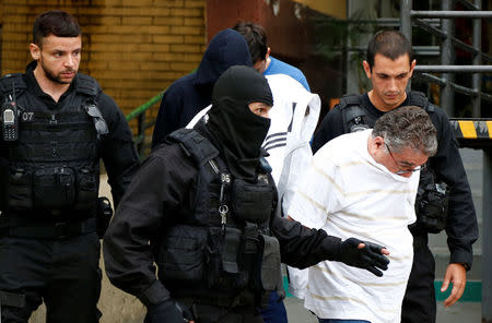 People detained during the probe known as "Operation Weak Flesh" are escorted by the police as they leave the Institute of Forensic Science in Curitiba, Brazil March 17, 2017. REUTERS/Rodolfo Buhrer