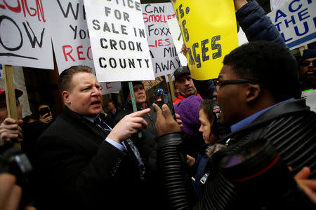 Ja'Mal Green faces off with a Fraternal Order of Police supporter protesting the handling of the Jussie Smollett case by the State's Attorney Kim Foxx in Chicago, Illinois, U.S., April 1, 2019. REUTERS/Joshua Lott