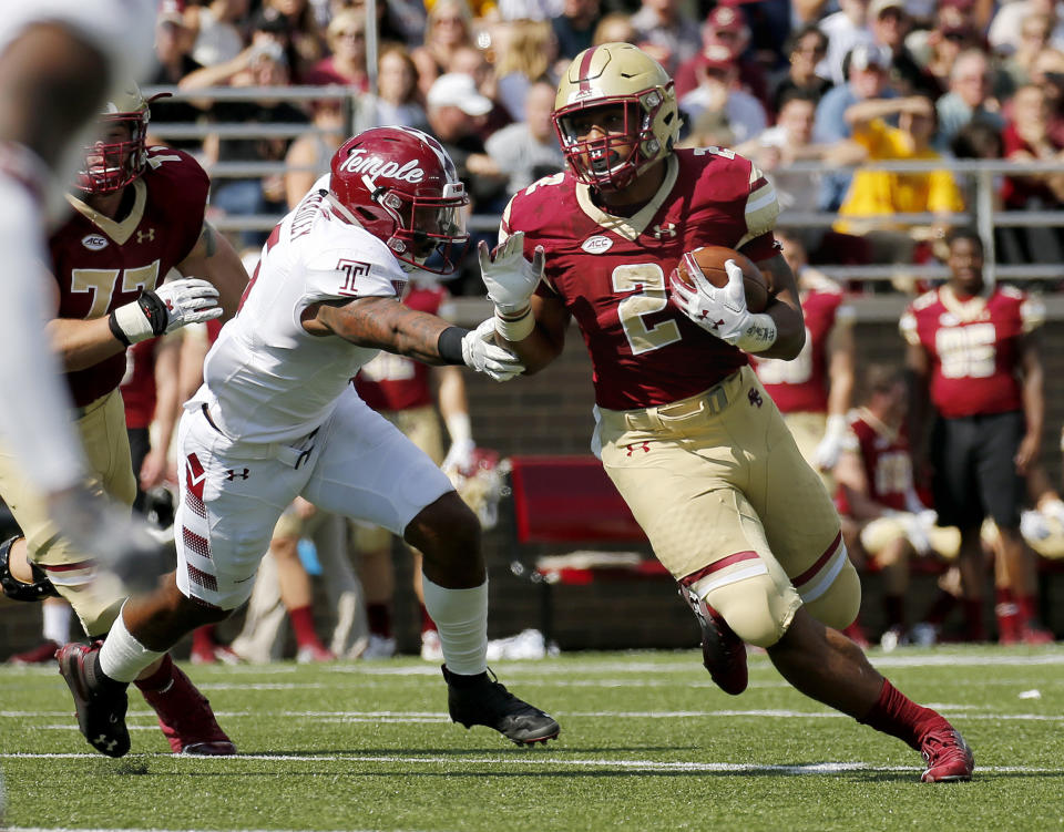 Boston College running back AJ Dillon (2) rushes with the ball ahead of Temple linebacker Shaun Bradley (5) during the first half of an NCAA college football game, Saturday, Sept. 29, 2018, in Boston. (AP Photo/Mary Schwalm)