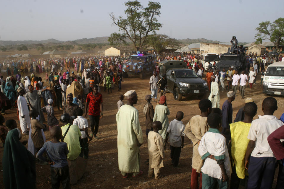 FILE- People gather to welcome then-recently freed students of the LEA Primary and Secondary School Kuriga upon arrival to reunite with there parents in Kuriga, Nigeria, Thursday, March 28, 2024. Their experience represents a worrying new development in Nigeria, Africa's most populous country where the mass abduction of Chibok schoolgirls a decade ago marked a new era of fear even as nearly 100 of the girls remain in captivity. An array of armed groups now focus on abducting schoolchildren, seeing in them a lucrative way to fund other crimes and control villages in the nation's mineral-rich but poorly-policed northwestern region. (AP Photo/Olalekan Richard, File)