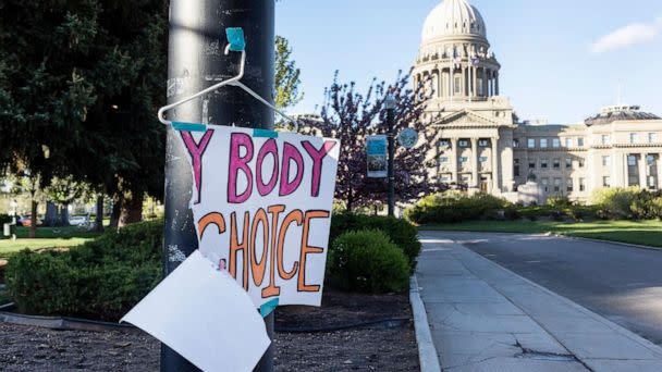 PHOTO: A torn sign reading 'My body my choice' on a hanger hangs on a streetlight in front of the Idaho State Capitol Building, May 3, 2022. (Idaho Statesman via AP, FILE)