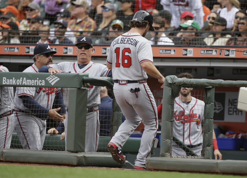 Atlanta Braves' Charlie Culberson (16) is greeted by manager Brian Snitker, second from left, after scoring the Braves' second run in the ninth inning of a baseball game against the San Francisco Giants Wednesday, Sept. 12, 2018, in San Francisco. Atlanta won the game 2-1. (AP Photo/Eric Risberg)