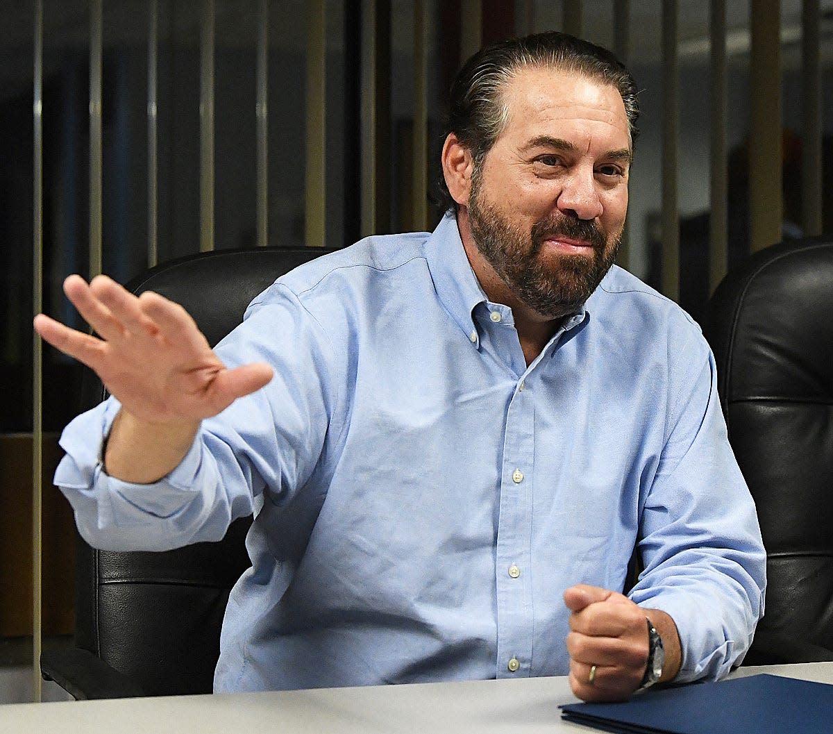 Arizona Attorney General Mark Brnovich gestures and smiles during his visit to the Yuma Sun in Yuma  on June 2, 2022.