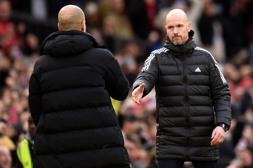 Manchester United's Dutch manager Erik ten Hag (R) shakes hands with Manchester City's Spanish manager Pep Guardiola