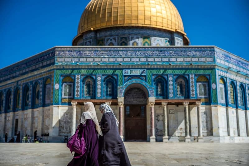 Two Muslim women walk in front of the Dome of the Rock mosque at Al Aqsa compound in Jerusalem. Israeli police have prevented hundreds of young Palestinians from entering a contested holy site in Jerusalem for the first prayer in the Muslim holy month of Ramadan, Israeli media reported on Monday. Ilia Yefimovich/dpa