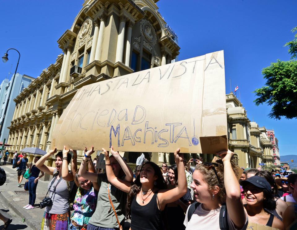 Women hold a sign during the Women's March in San Jose, Costa Rica on January 21, 2017. Hundreds of people packed the streets of San Jose in a massive outpouring of defiant opposition to US hardline new president, Donald Trump.&nbsp;