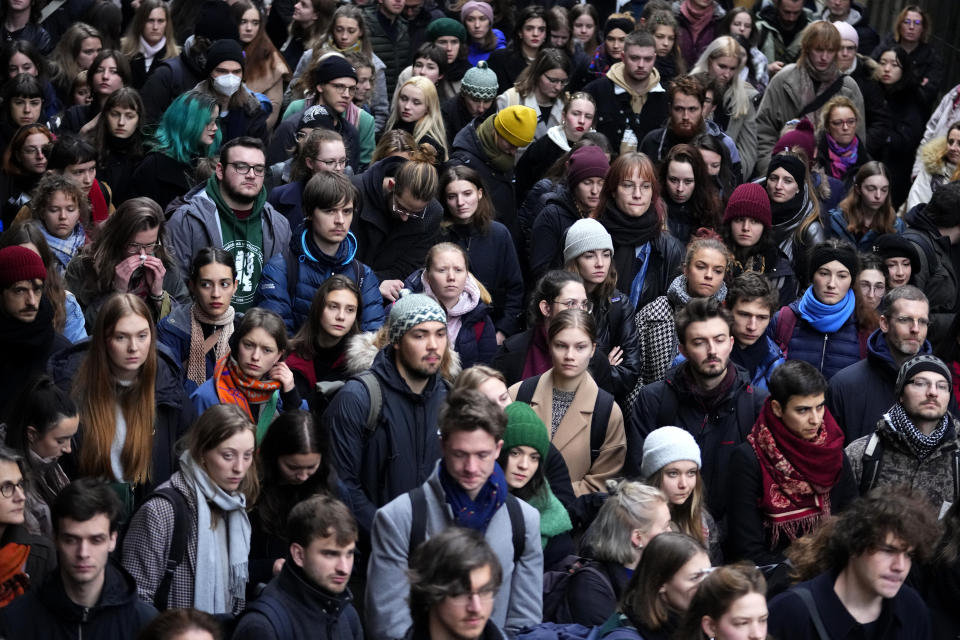 People gather in front of headquarters of Charles University in Prague, Czech Republic, Thursday, Jan. 4, 2024. Thousands of students and other Czechs marched in silence in the Czech capital on Thursday to honor the victims of the country's worst mass killing that left 14 dead on Dec. 21, 2023.(AP Photo/Petr David Josek)