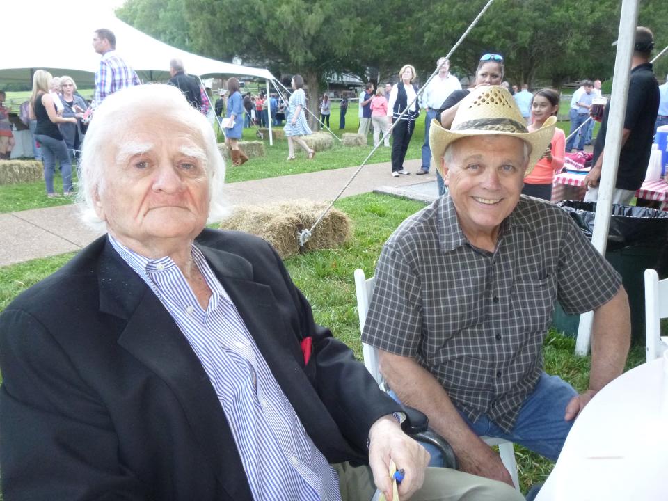 Museum of Appalachia founder John Rice Irwin, left, and columnist Sam Venable visit during a museum Barn Dance emceed by Venable.