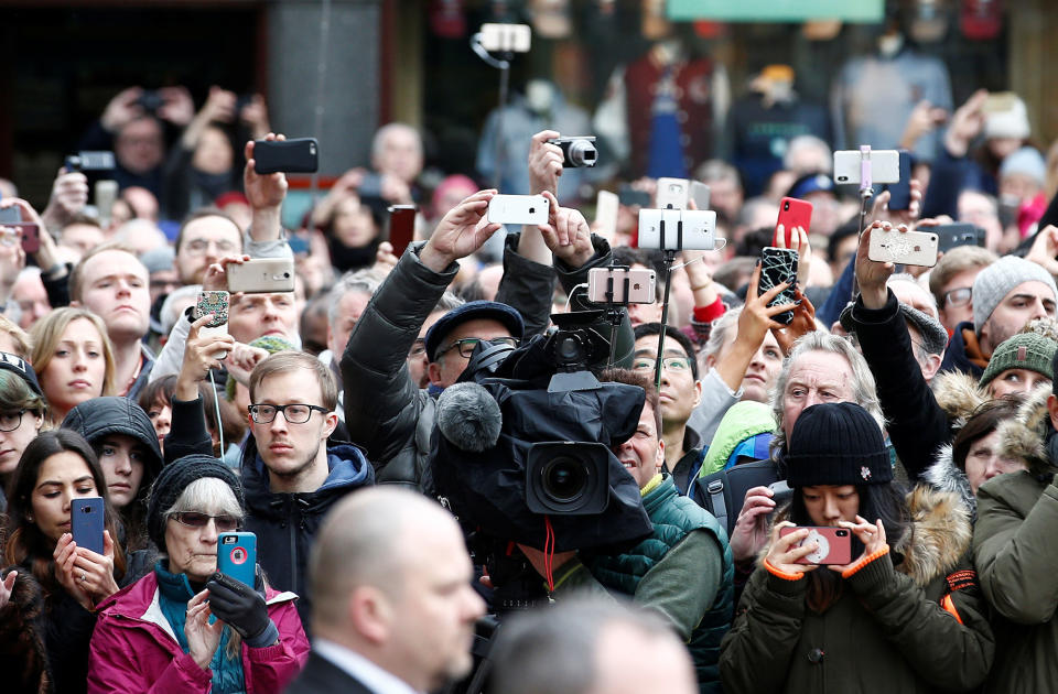 <p>Members of the public and media photograph the funeral cortege as it arrives at Great St Marys Church, where the funeral of theoretical physicist Prof Stephen Hawking is being held, in Cambridge, England, March 31, 2018. (Photo: Henry Nicholls/Reuters) </p>