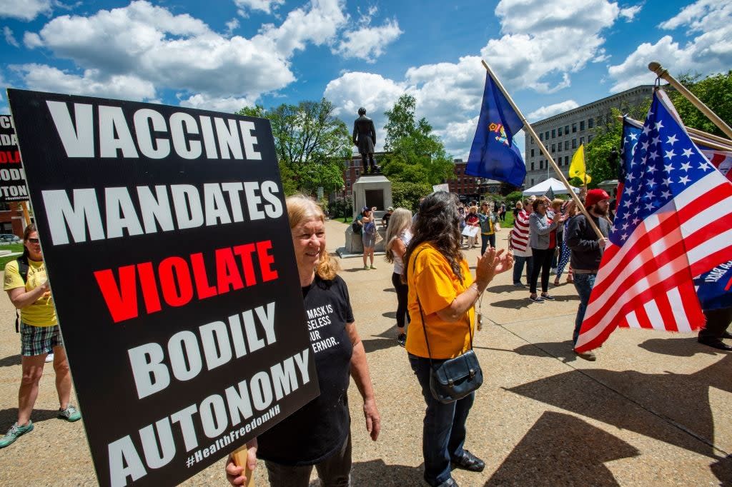 Protesters at an anti-mask and anti-vaccine rally in New Hampshire, 15 May (AFP via Getty Images)