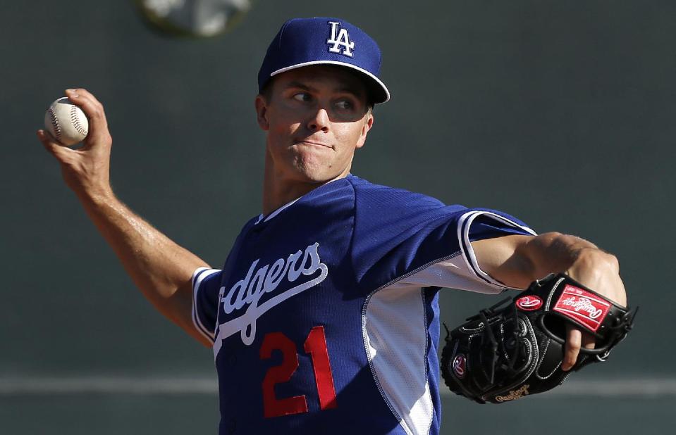 FILE - In this Monday, Feb. 10, 2014 file photo, Los Angeles Dodgers pitcher Zack Greinke throws during spring training baseball practice in Glendale, Ariz. Greinke and the Los Angeles Dodgers have knocked Rodriguez and the New York Yankees off baseball's payroll perch. The Dodgers as of Tuesday, March 25, 2014 had a projected payroll of $235 million, according to study of all major league contracts by The Associated Press. (AP Photo/Paul Sancya, File)