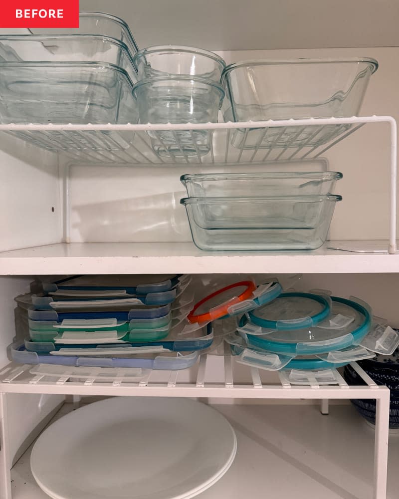 Food storage lids disorganized in cabinet.