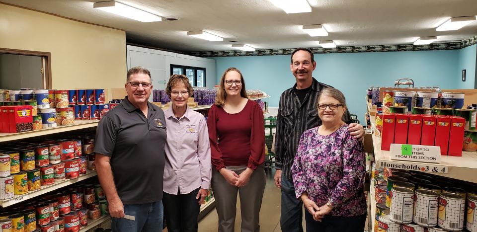 Love Center Food Pantry Directors Edgar and Polly Raber, from left, Eva Durbin (race director) and Jim and Joanne Morrison (race committee members) at the Love Center Food Pantry, which received its biggest donation yet of $6,800 from the Millersburg Food Run, held in July.