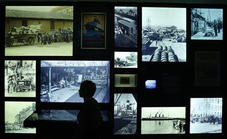 U.S. author Sonia Pressman Fuentes from Sarasota, Florida, walks past photos at the "Millions of People, One Dream" exhibition at the Red Star Line Museum in Antwerp September 24, 2013. REUTERS/Yves Herman