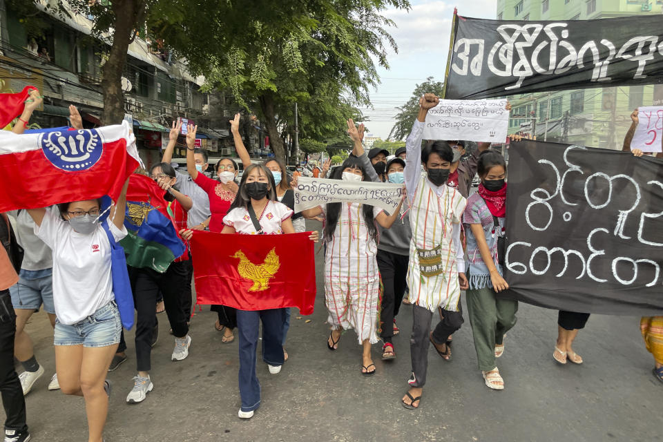 FILE - Pro-democracy protesters hold a flash mob rally to protest against Myanmar's military-installed government, at Kyauktada township in Yangon, Myanmar on Dec. 20, 2021. When the army moved to overthrow Myanmar's elected government in the early hours of Feb. 1, 2021, to overthrow the elected government of Aung San Suu Kyi, it looked like a walkover that could entrench the military in power indefinitely. Three years later, a poorly armed but popular and politically savvy grassroots resistance movement has shaken the military’s grip, in a modern-day David vs. Goliath scenario, but the costs have been high.(AP Photo/File)