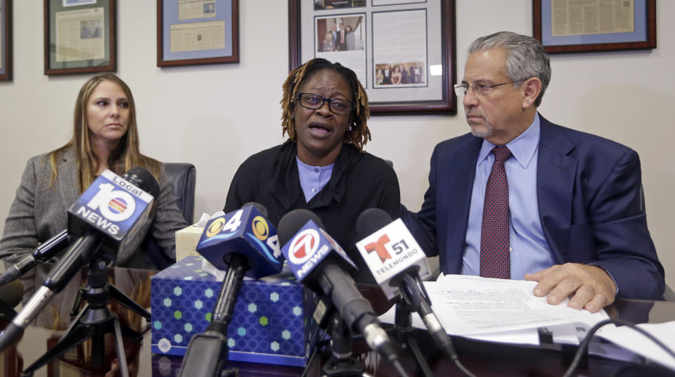 Gina Alexis, center, mother of 14-year-old Nakia Venant, who livestreamed her suicide on Facebook over the weekend, flanked by attorneys Stacie J. Schmerling, left, and Howard M. Talenfeld, right, weeps as she answers a question during a news conference, Wednesday, Jan. 25, 2017, shows a in Plantation, Fla. Nakia Venant's suicide is at least the third to be livestreamed nationally in the last month. (AP Photo/Alan Diaz)