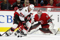 Ottawa Senators' Connor Brown (28) tries to regain control of the puck to shoot on Carolina Hurricanes goaltender Antti Raanta (32) during the second period of an NHL hockey game in Raleigh, N.C., Thursday, Dec. 2, 2021. (AP Photo/Karl B DeBlaker)